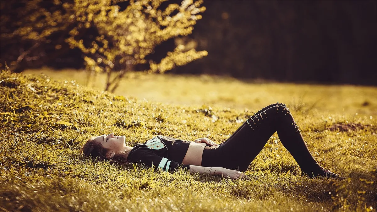 how to recover from burnout after quitting — woman sitting quietly by window looking tired but calm, ETEO Wellness — Ava